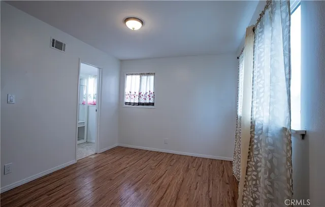a view of a room with wooden floor and plant