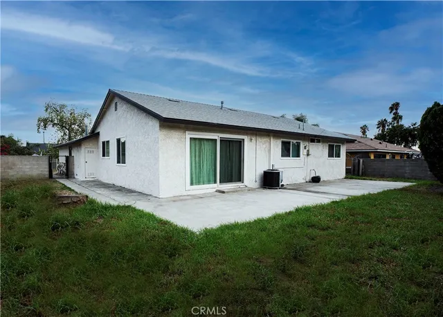 a front view of a house with a garden and yard