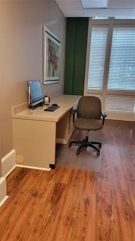 a workspace with furniture and wooden floor