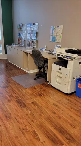 a room with furniture and view of kitchen