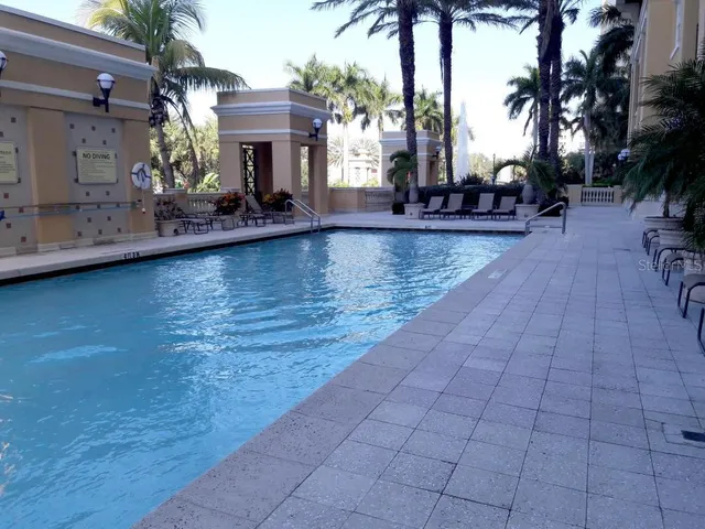 a view of swimming pool with outdoor seating and a forest