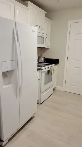 a white refrigerator freezer sitting inside of a kitchen