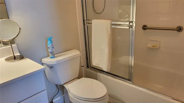 a white toilet sitting next to a bathroom sink