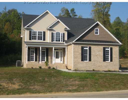 Exterior Front. Brand new and just completed!  Charming cottage style.  Long transomed windows, warm tones in the brick, contrasting "shakes" in the gable and a lavish pinched tin awning over the garage give this home a lot of curb appeal!  The lot is gorgeous.