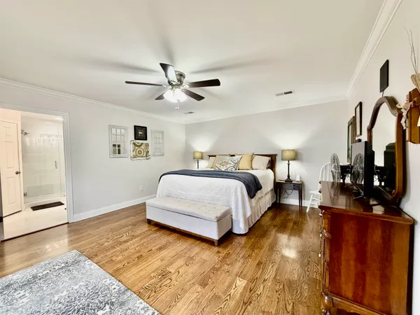 a spacious bedroom with a bed and a walk in closet