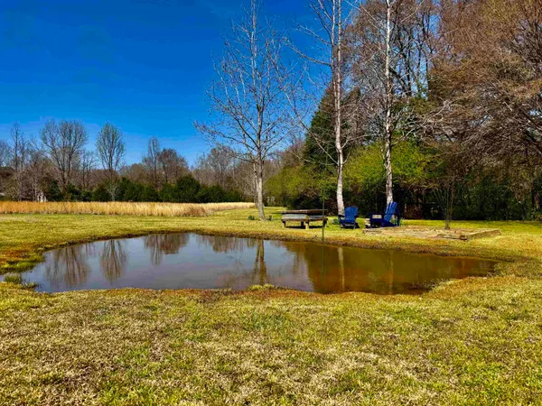 a view of swimming pool with outdoor seating and yard