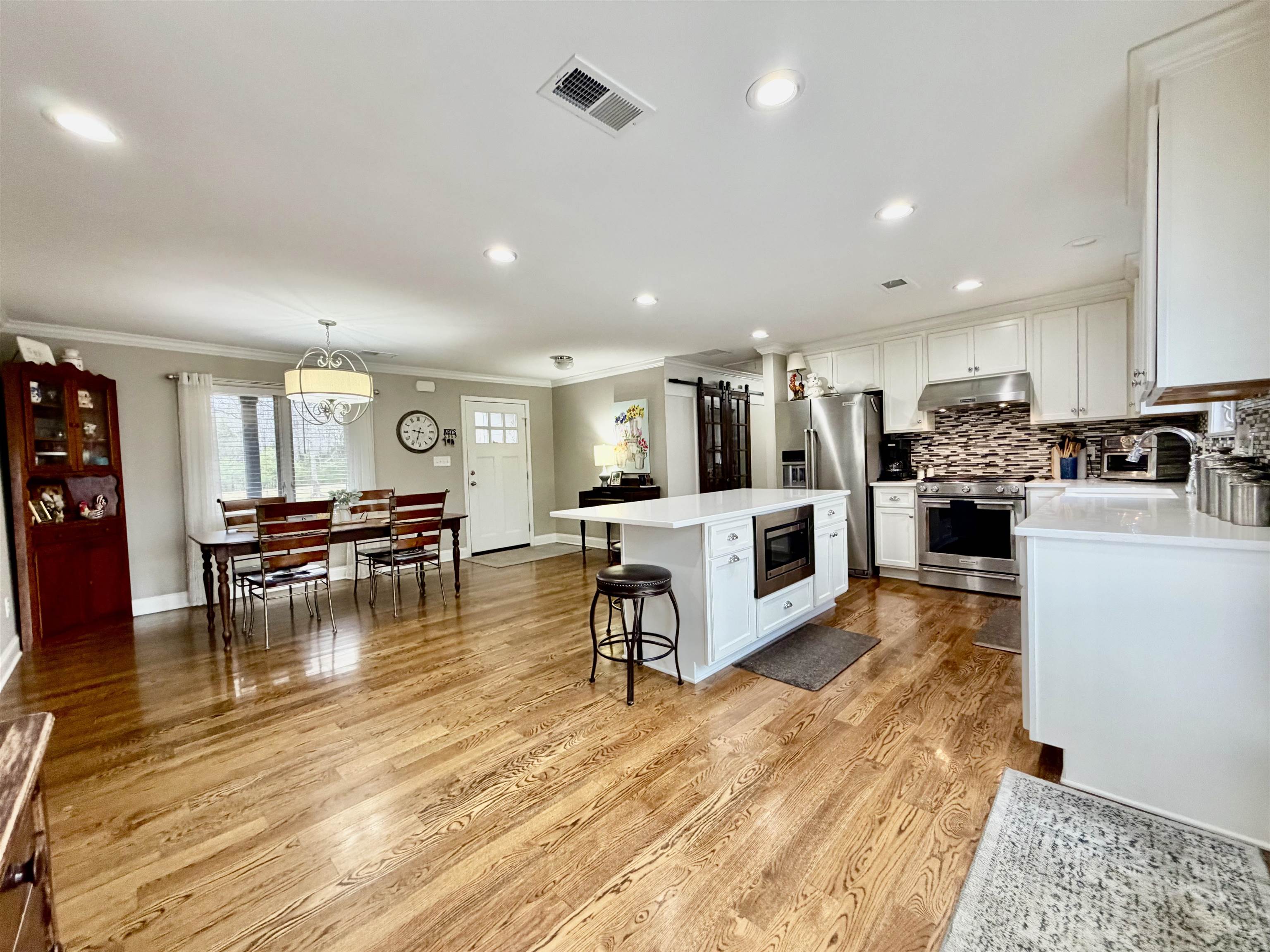 6195 Bobbitt Road Moscow, TN 38057 - Photo 4 of 40 a living room with stainless steel appliances furniture and a wooden floor