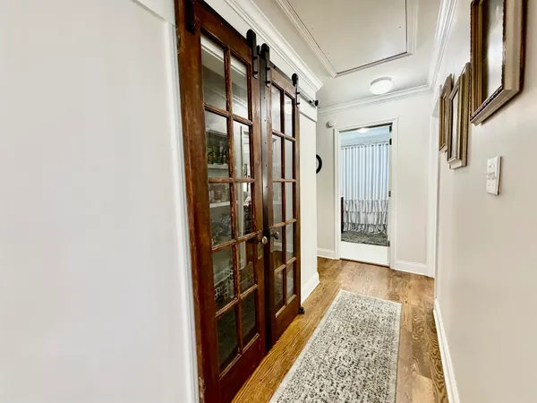 a view of hallway with wooden floor