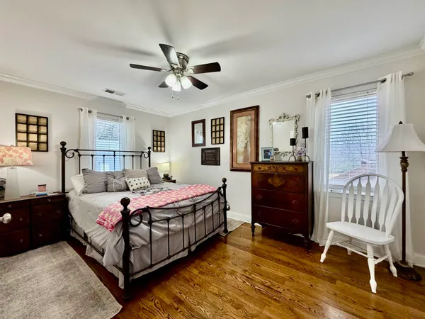 a bedroom with a bed and a dresser in it