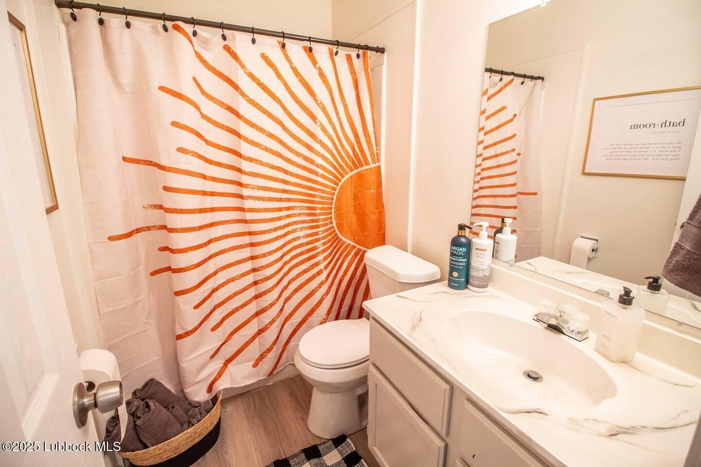 5808 6th Street, Unit B Lubbock, TX 79416 - Photo 16 of 23 a bathroom with a sink toilet and mirror