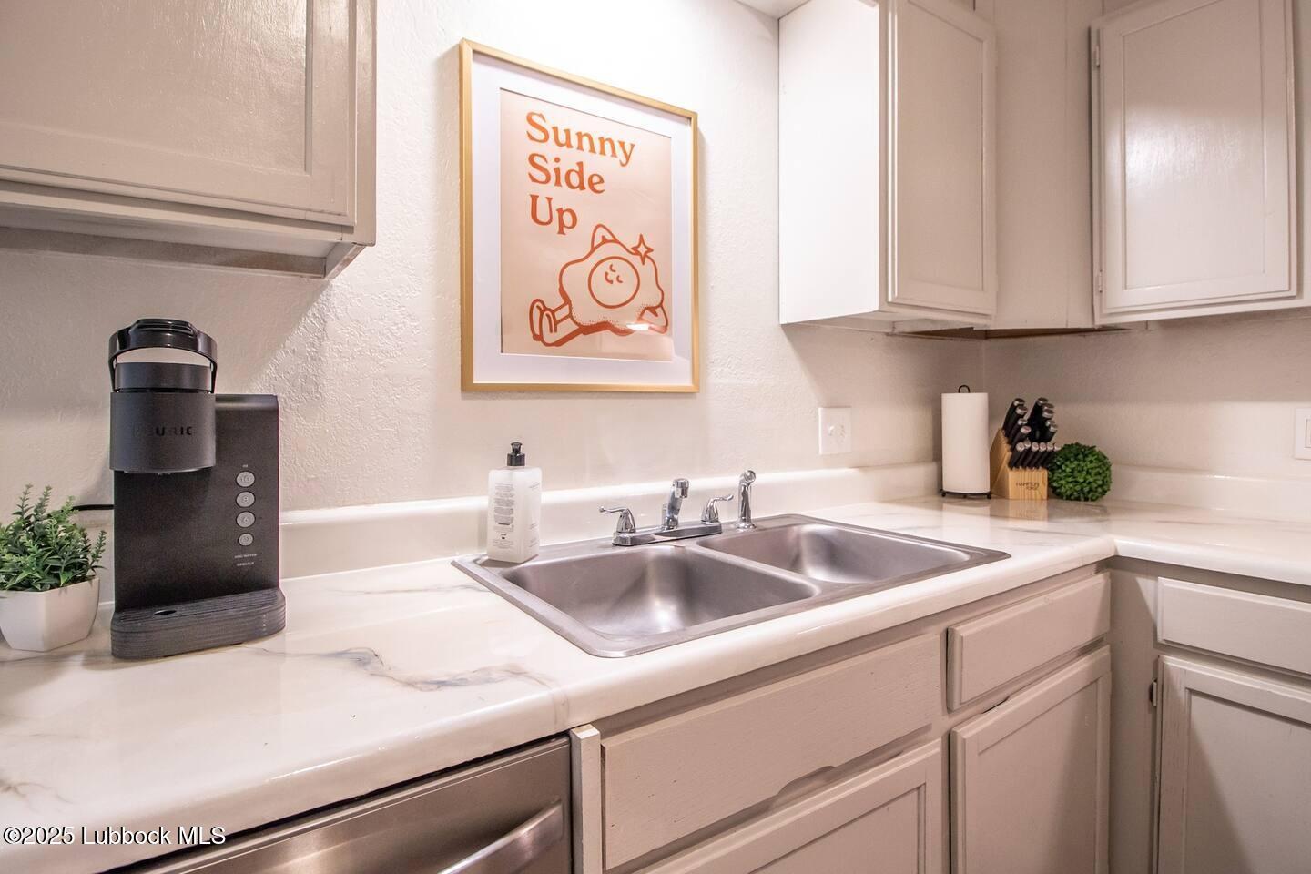 5808 6th Street, Unit B Lubbock, TX 79416 - Photo 9 of 23 a kitchen with stainless steel appliances granite countertop a sink and a refrigerator