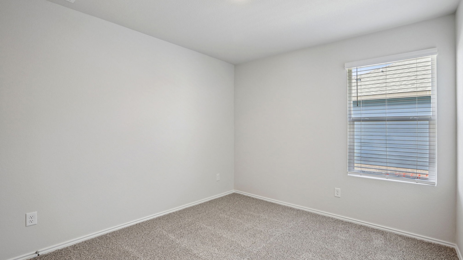156 Wyatt Way Jarrell, TX 76537 - Photo 27 of 30 Neutral wall paint, textured carpeting, and white baseboards