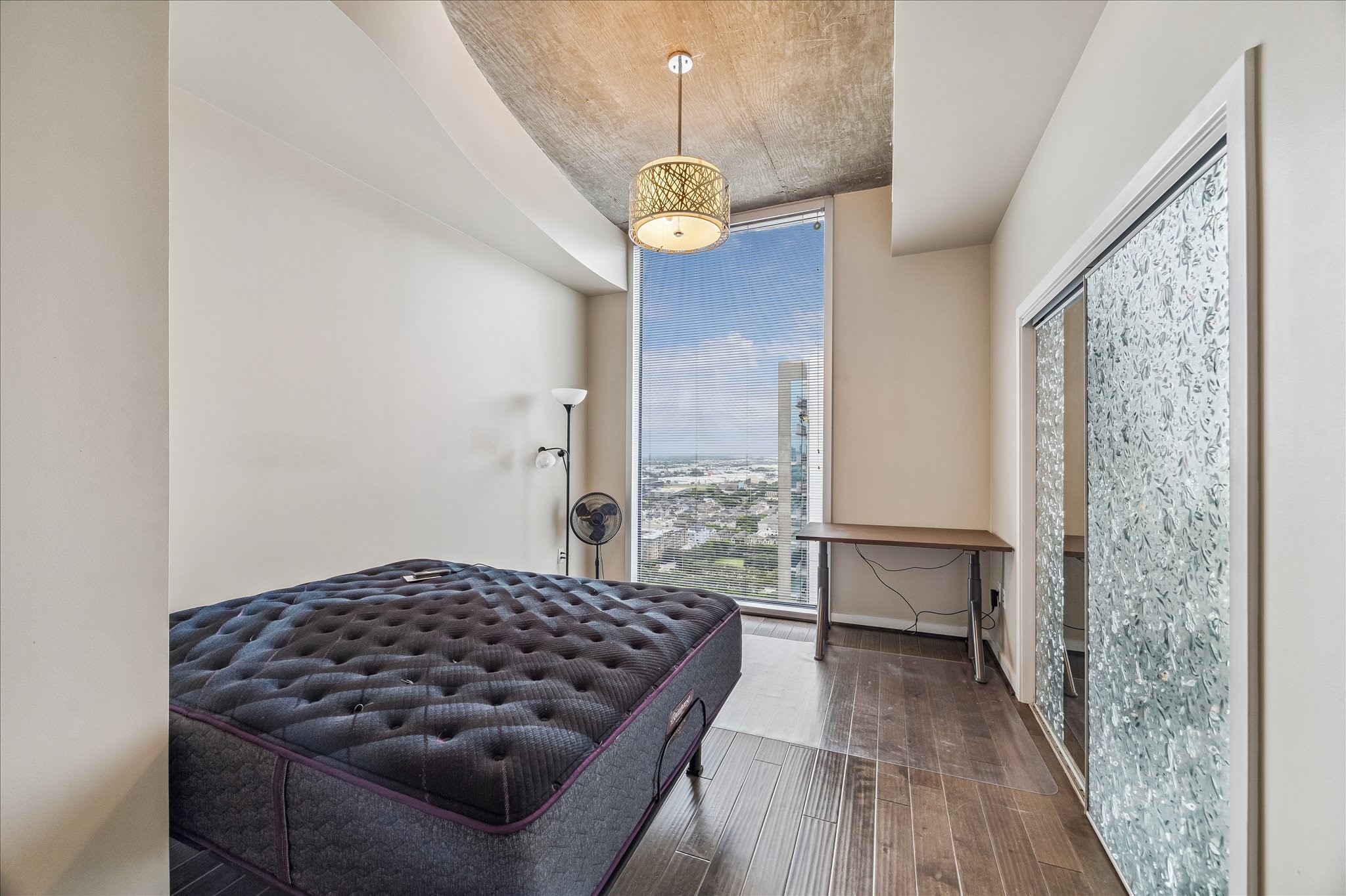 5925 Almeda Road, Unit 12704 Houston, TX 77004 - Photo 7 of 31 Wake up to spectacular city and Medical Center views from this private bedroom retreat. Floor-to-ceiling windows bring in abundant natural light, while contemporary finishes create a relaxing and modern atmosphere.