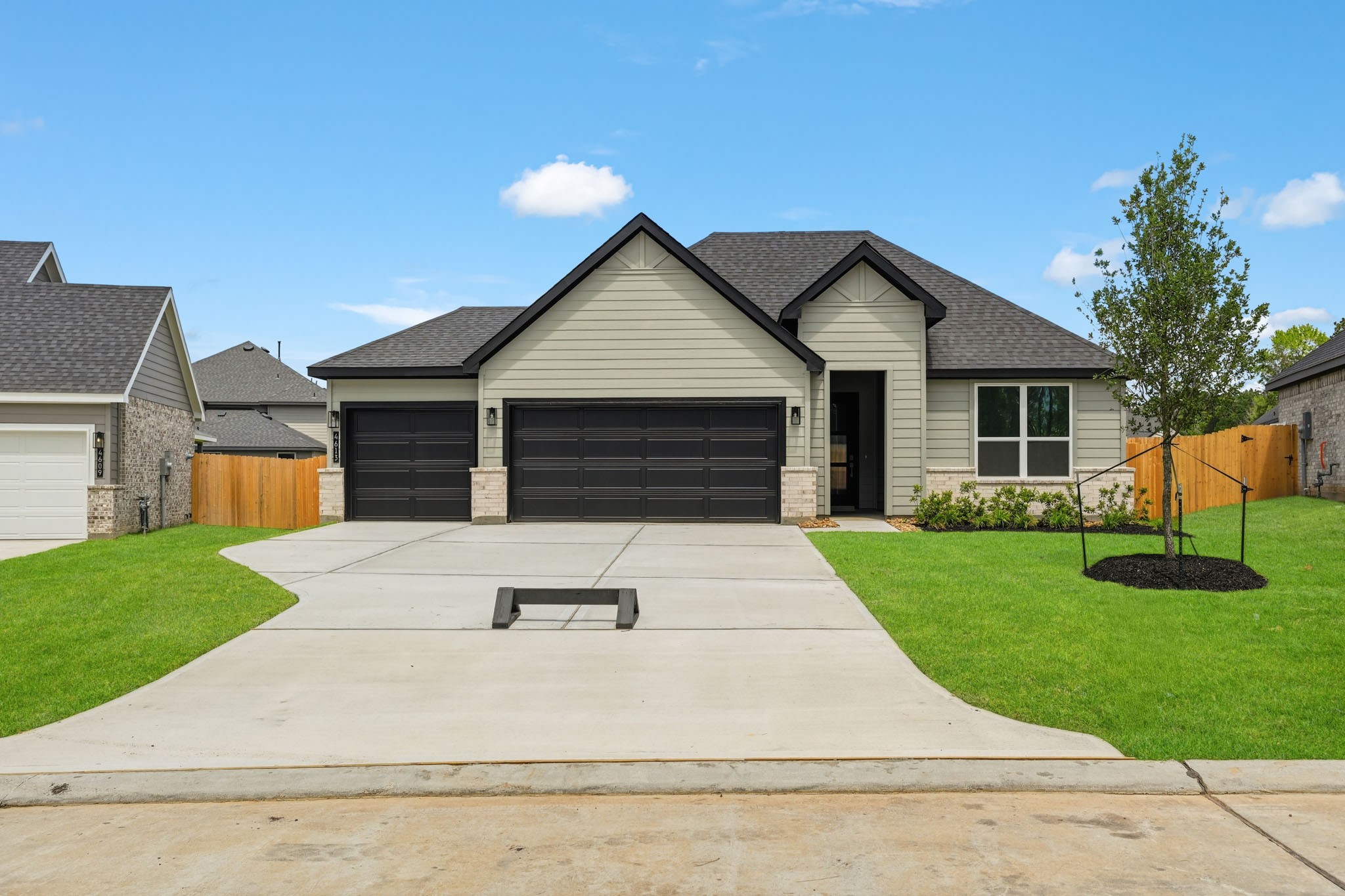4613 Vernal Loop Conroe, TX 77303 - Photo 1 of 35 a front view of a house with a yard and garage