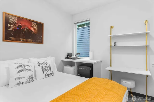 a bedroom with a bed and a desk