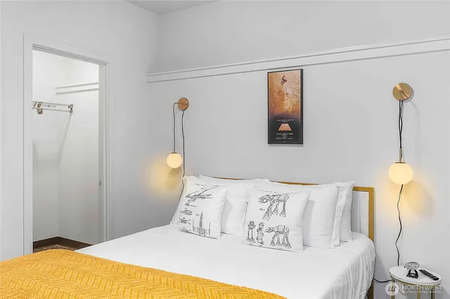 a bedroom with a bed and a lamp with the view of a small room