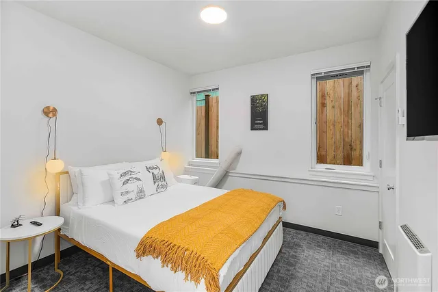 a bedroom with a bed and a window