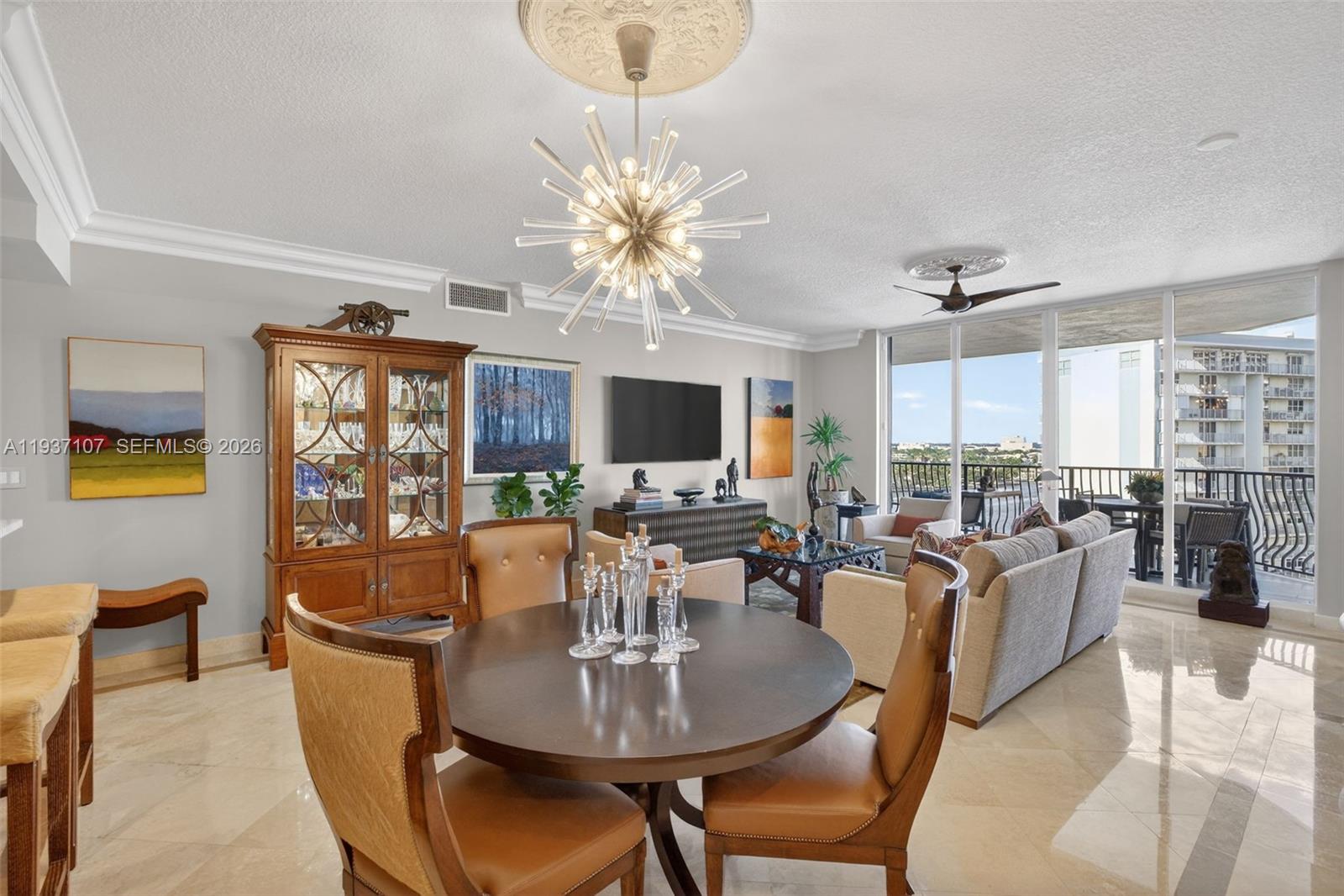 100 South Birch Road, Unit 1103F Fort Lauderdale, FL 33316 - Photo 26 of 80 Beautiful sputnik chandelier, Emtek crystal door hardware throughout unit, counter seating at kitchen. Crown molding.