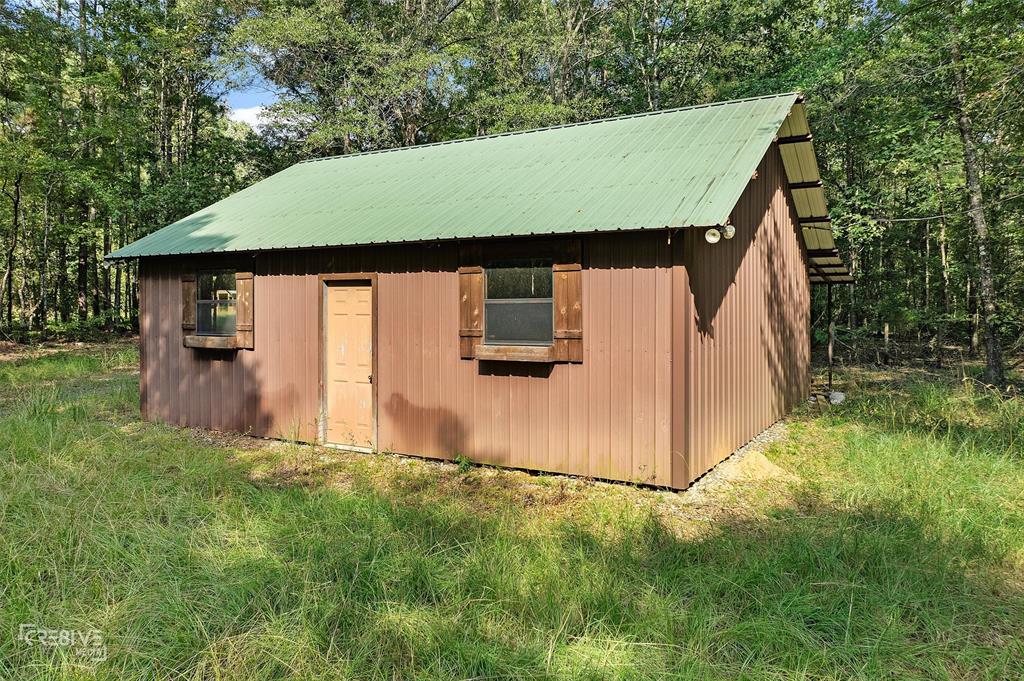 356 Cottage Grove Road Benton, LA 71006 - Photo 11 of 15 a backyard of a house with lots of green space