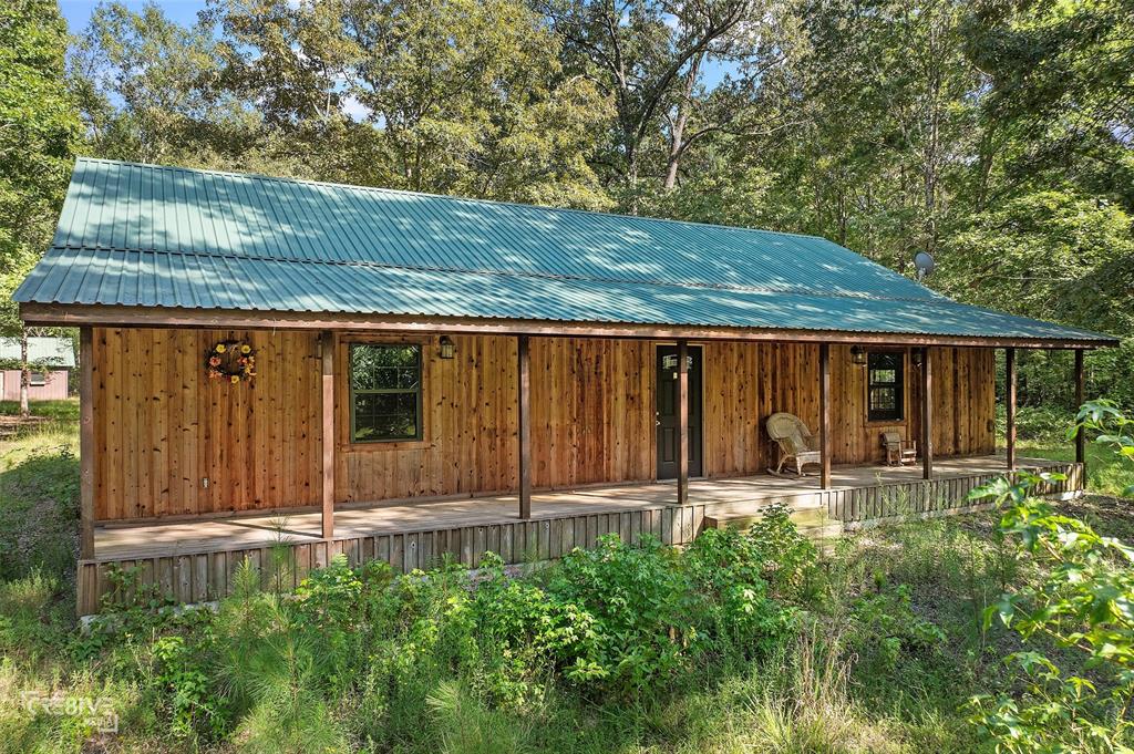 356 Cottage Grove Road Benton, LA 71006 - Photo 13 of 15 a backyard of a house with table and chairs