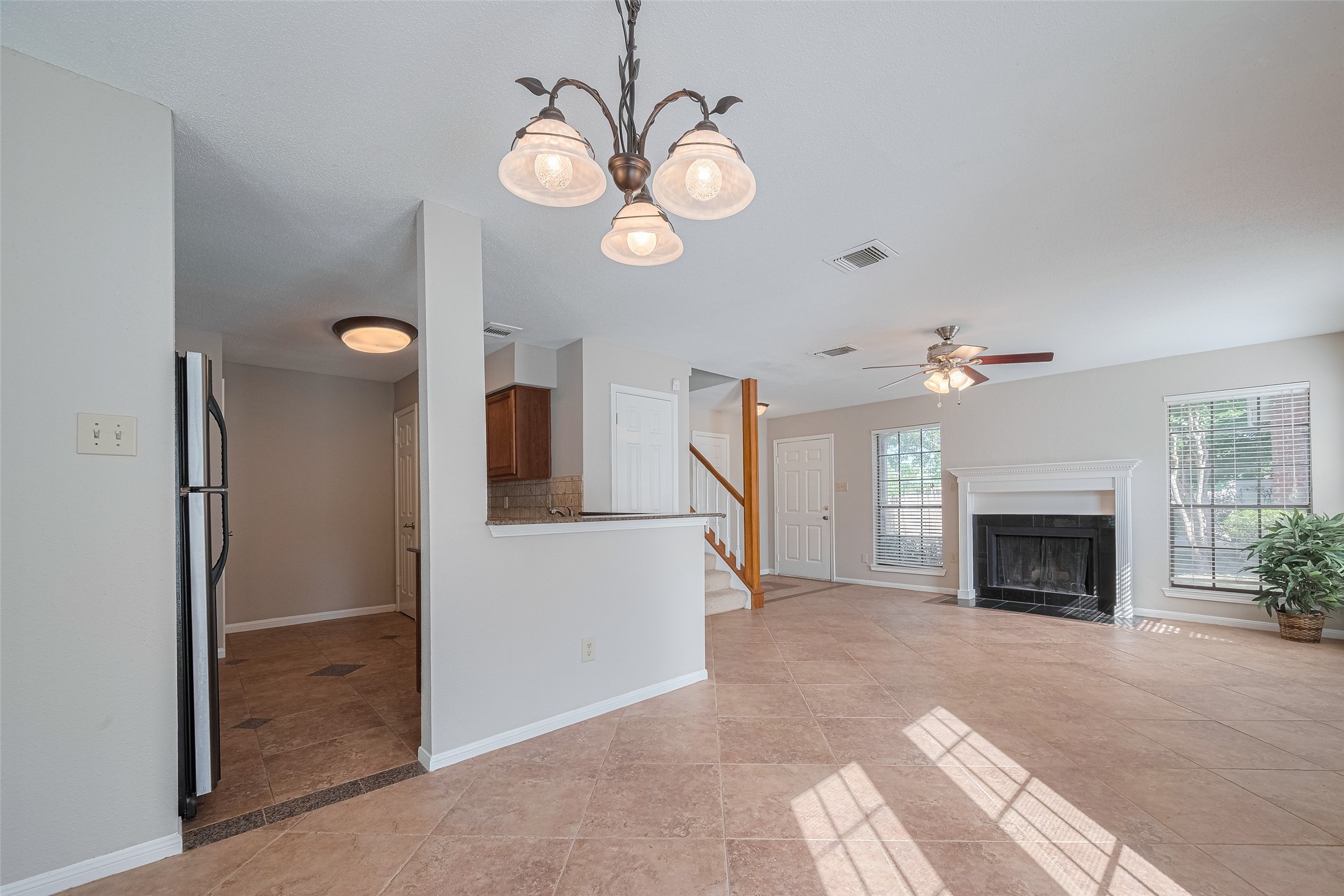 2211 South Kirkwood Road, Unit 19 Houston, TX 77077 - Photo 11 of 39 a view of a livingroom with an empty space and a fireplace