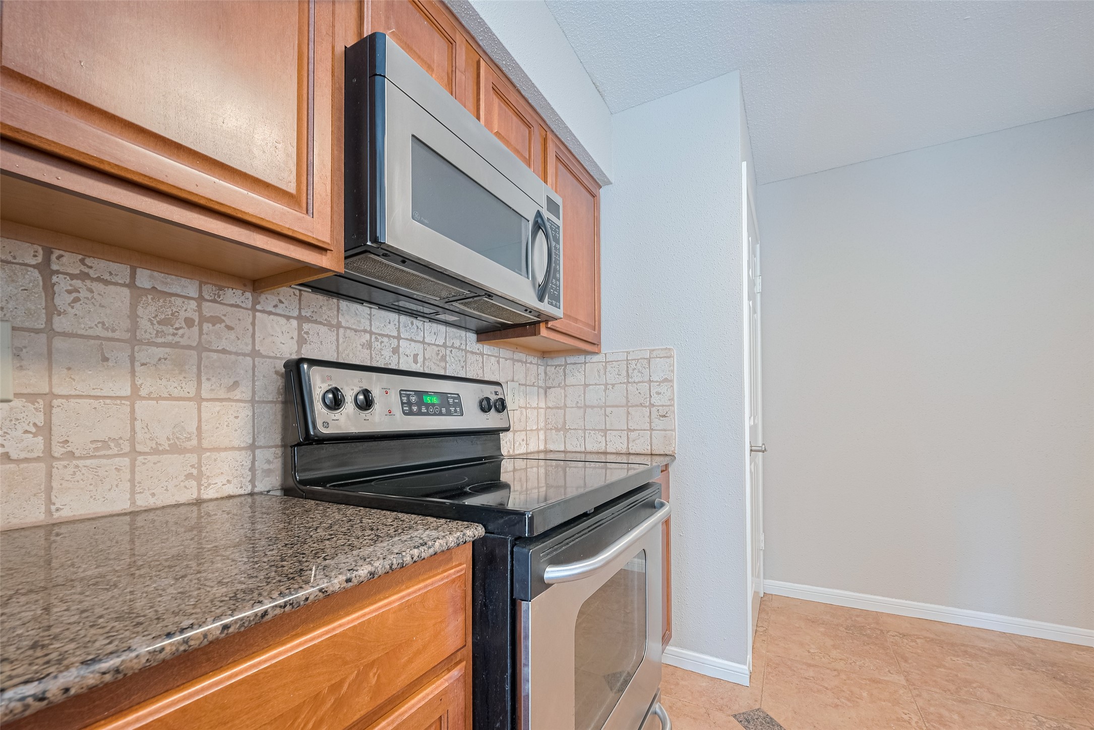 2211 South Kirkwood Road, Unit 19 Houston, TX 77077 - Photo 16 of 39 a kitchen with stainless steel appliances granite countertop a sink and a stove