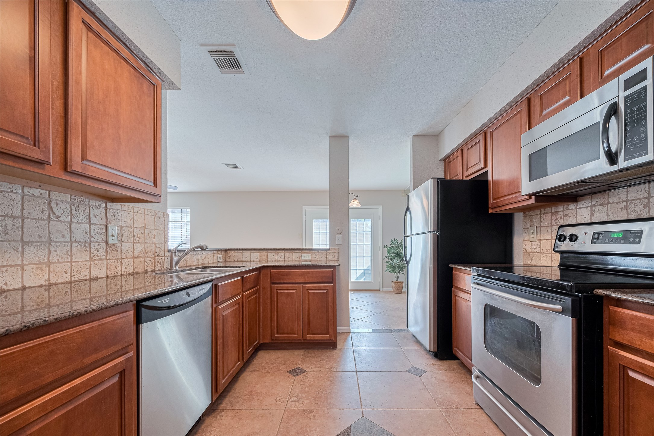 2211 South Kirkwood Road, Unit 19 Houston, TX 77077 - Photo 19 of 39 a kitchen with stainless steel appliances granite countertop a sink stove and refrigerator