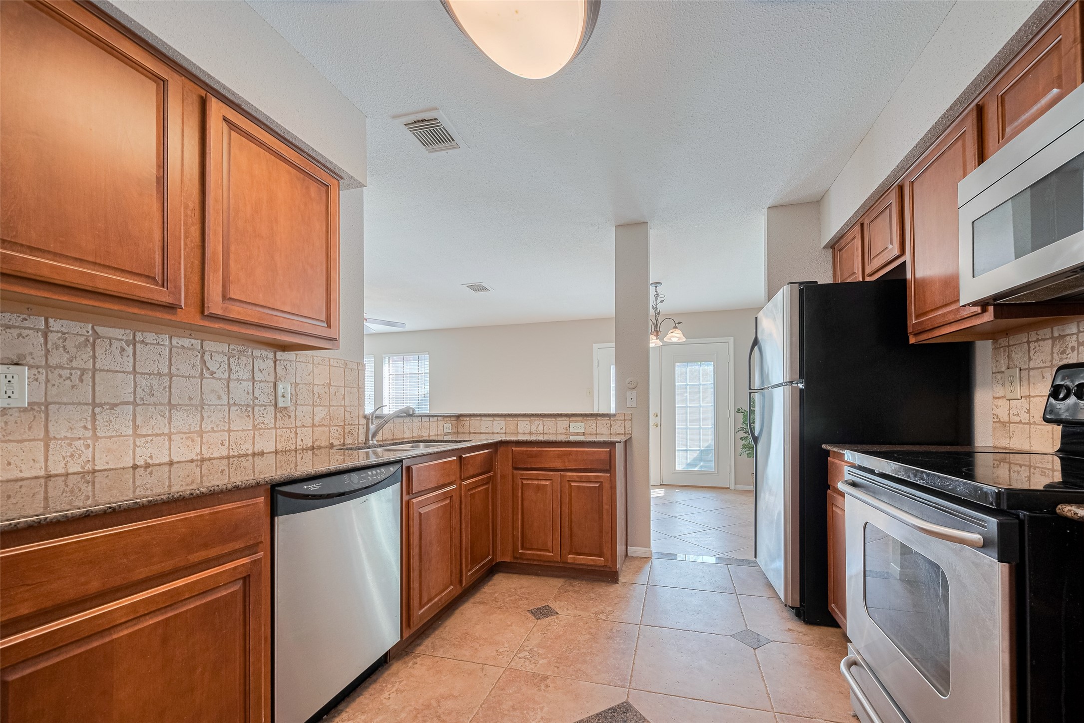 2211 South Kirkwood Road, Unit 19 Houston, TX 77077 - Photo 21 of 39 a kitchen with stainless steel appliances granite countertop a sink stove and refrigerator