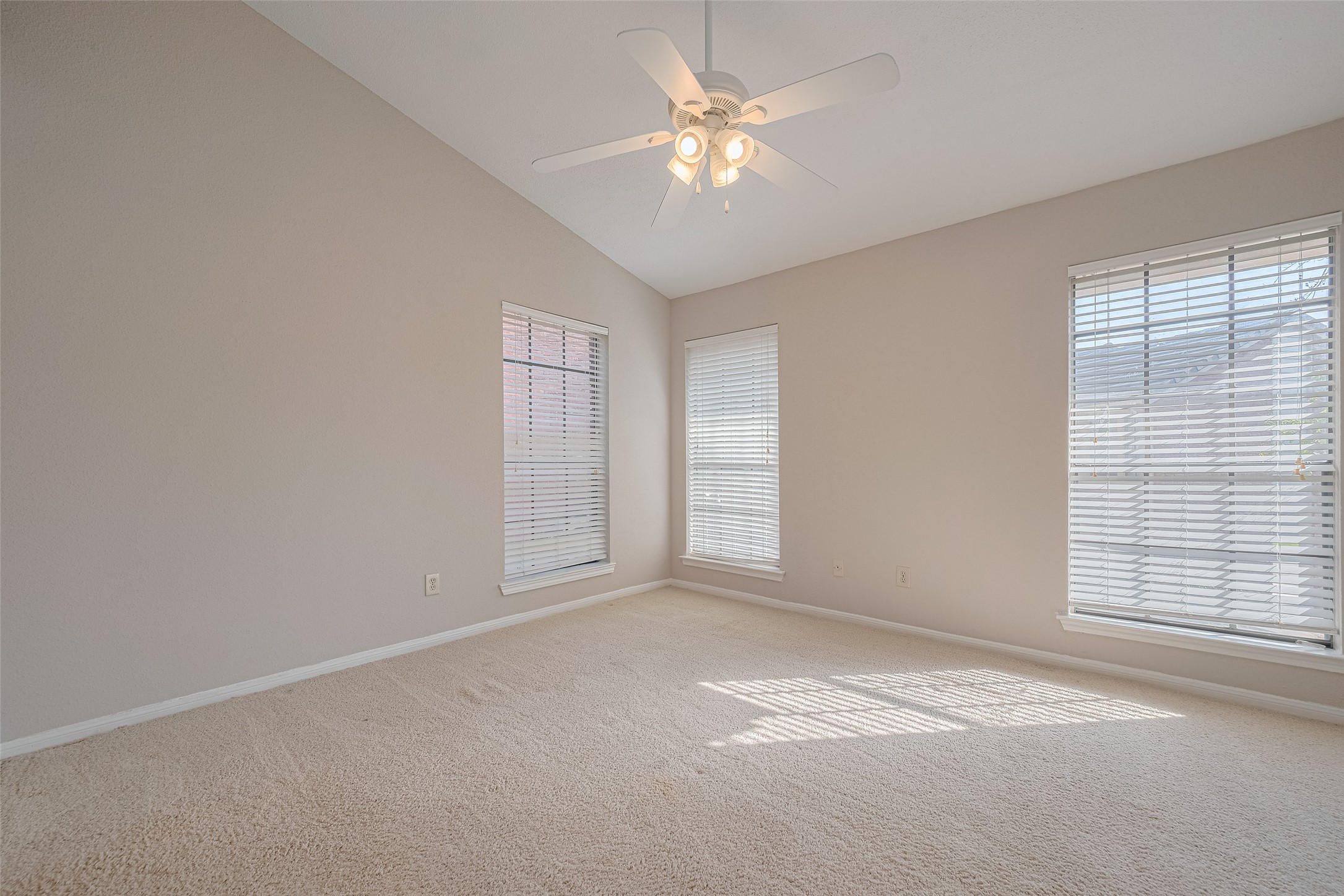 2211 South Kirkwood Road, Unit 19 Houston, TX 77077 - Photo 22 of 39 an empty room with windows and chandelier fan