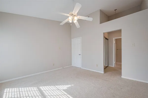 a view of an empty room with a fan