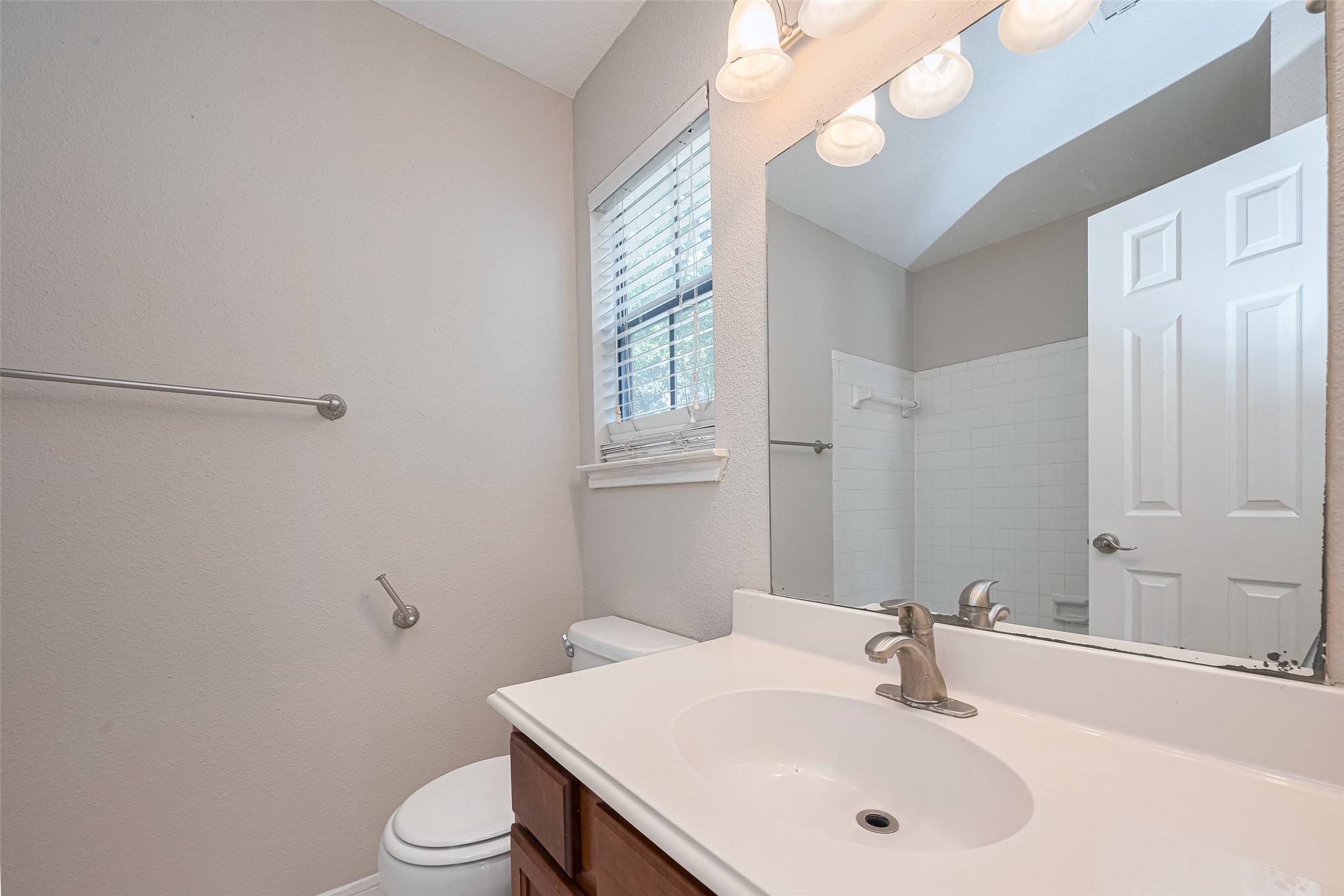 2211 South Kirkwood Road, Unit 19 Houston, TX 77077 - Photo 26 of 39 a bathroom with a sink vanity mirror and toilet