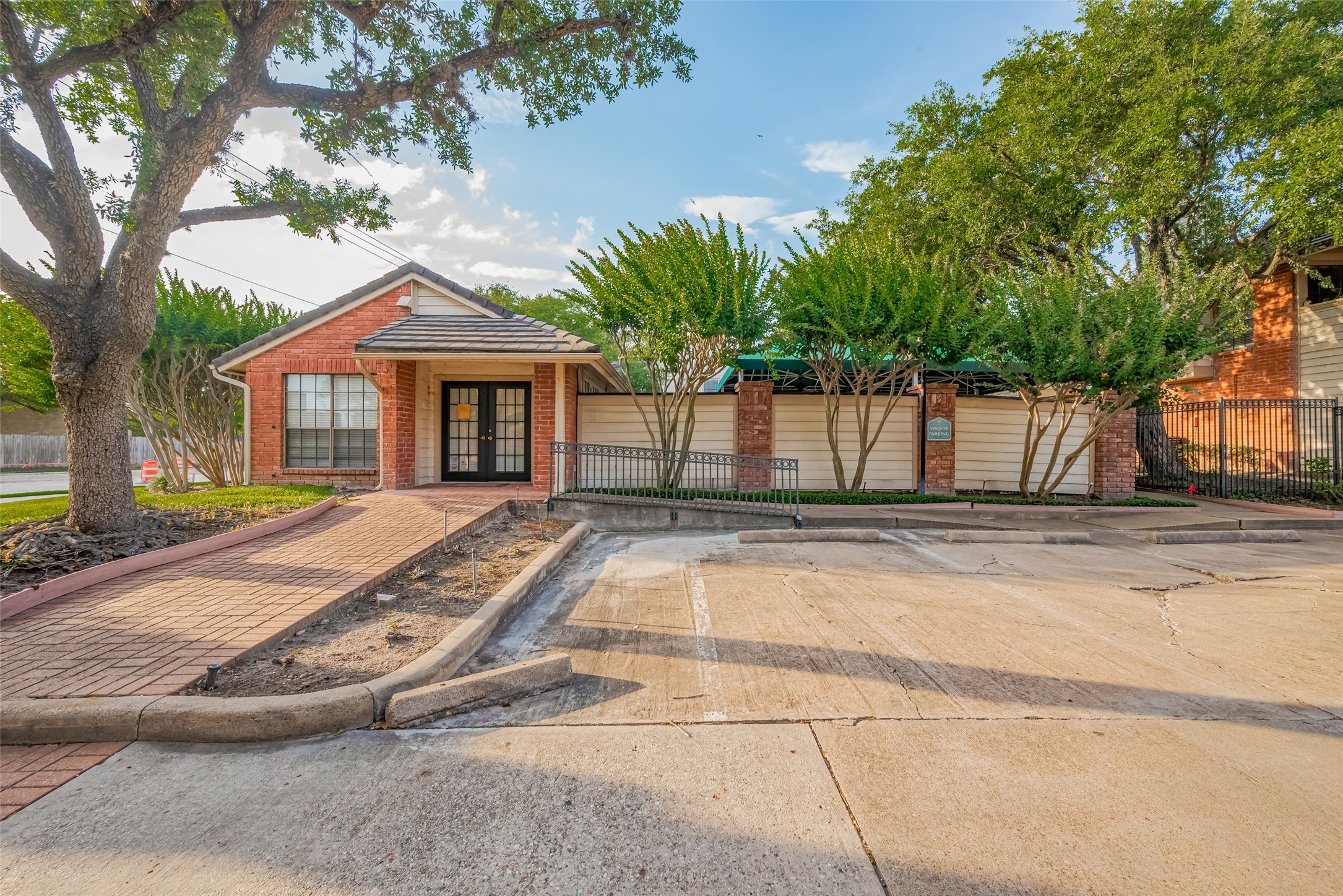 2211 South Kirkwood Road, Unit 19 Houston, TX 77077 - Photo 38 of 39 a view of a white house with a large tree and wooden fence