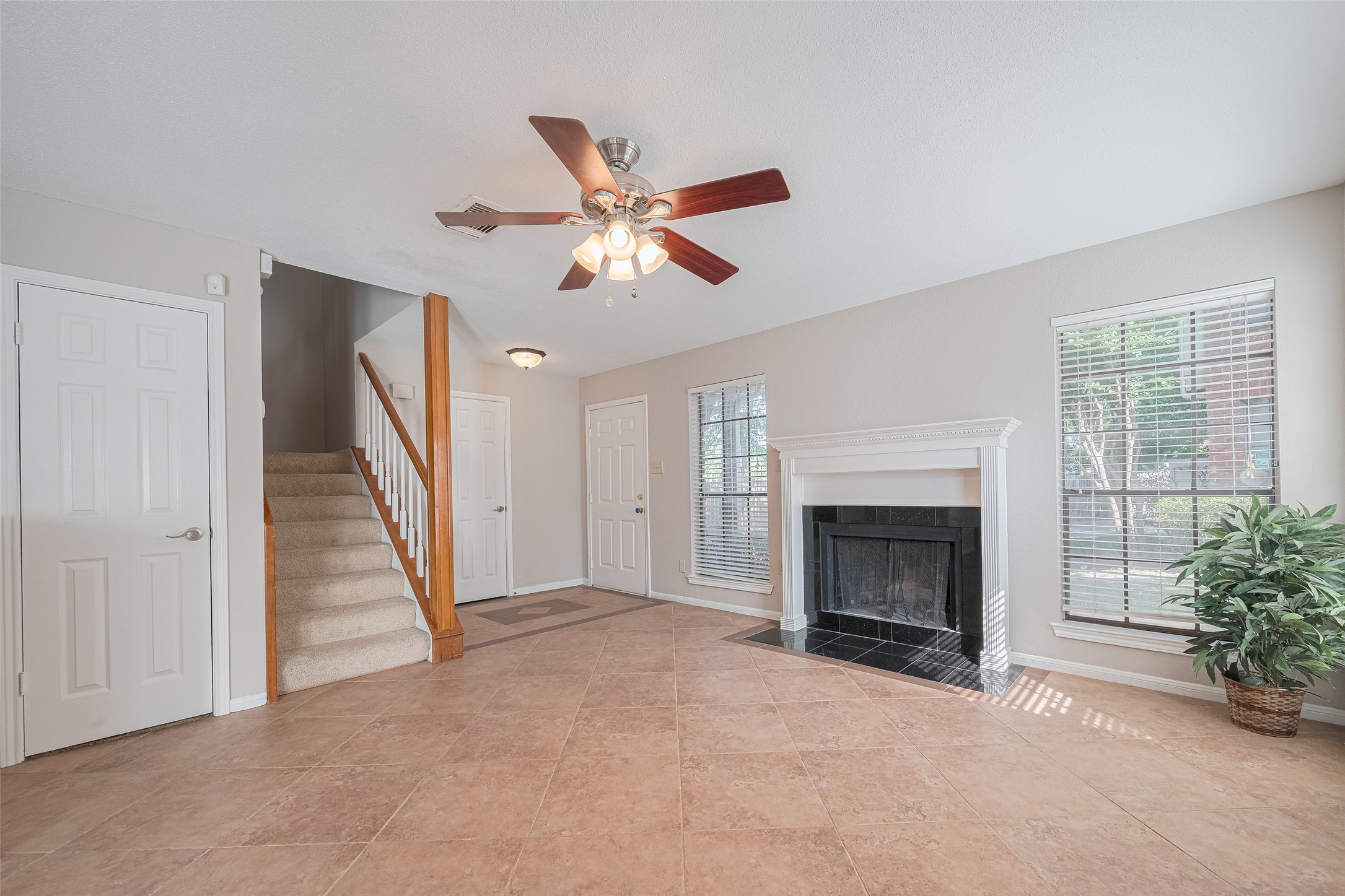 2211 South Kirkwood Road, Unit 19 Houston, TX 77077 - Photo 8 of 39 a view of a livingroom with a fireplace and a chandelier fan
