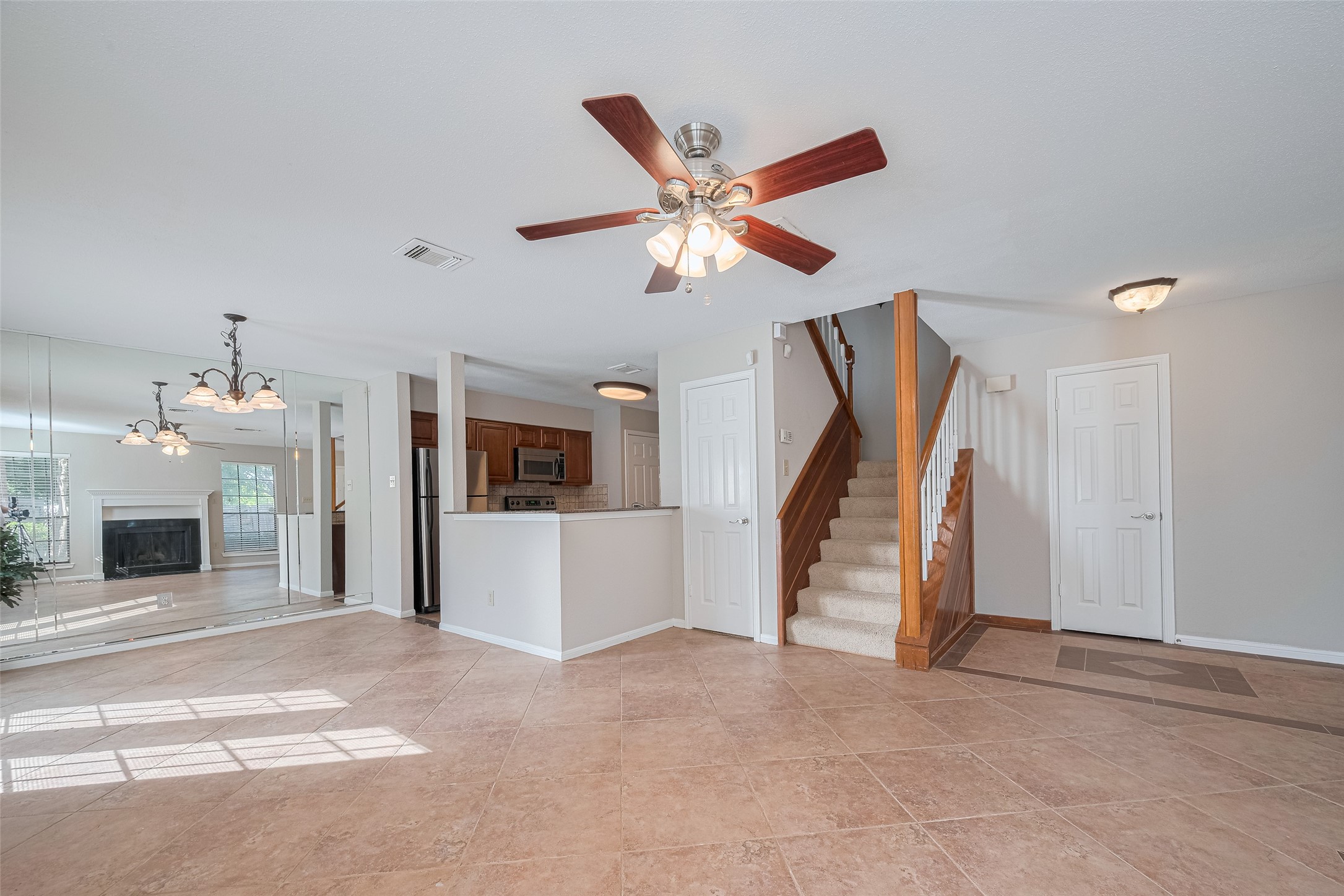 2211 South Kirkwood Road, Unit 19 Houston, TX 77077 - Photo 9 of 39 a view of a livingroom with a staircase and a ceiling fan