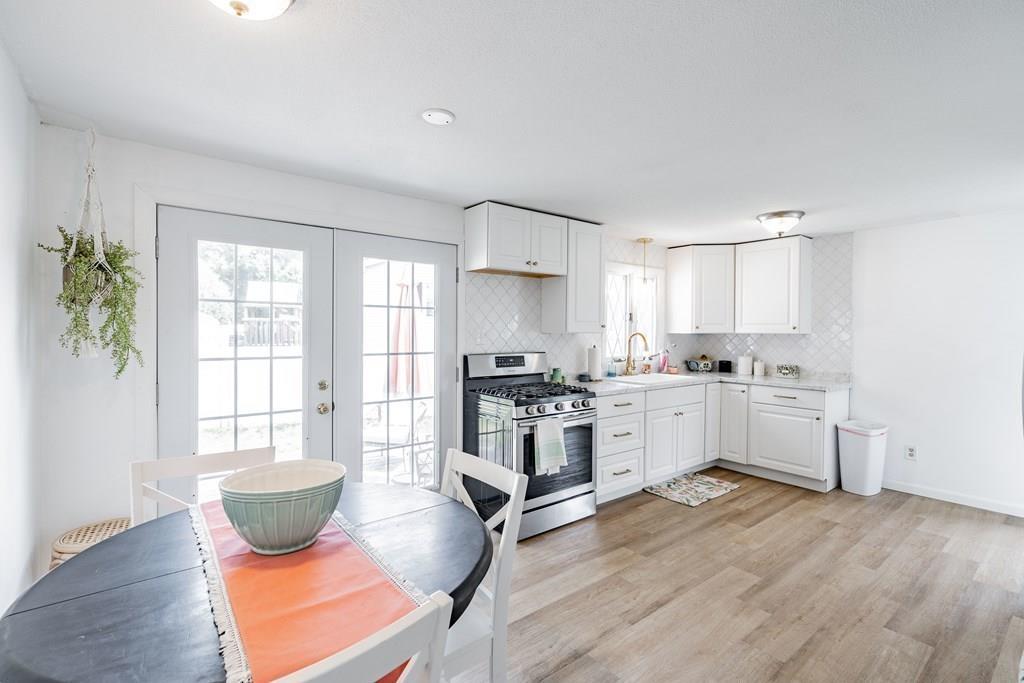 35 Calley Street Springfield, MA 01129 - Photo 3 of 18 a kitchen with a stove a sink and a refrigerator