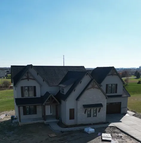 a view of a big house with a big yard