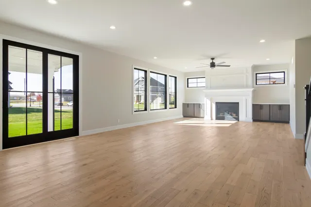 an empty room with furniture and a fireplace