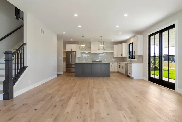 a large kitchen with a large window and stainless steel appliances