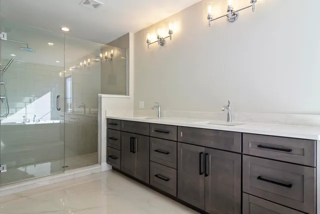 a bathroom with double vanity sink and mirror