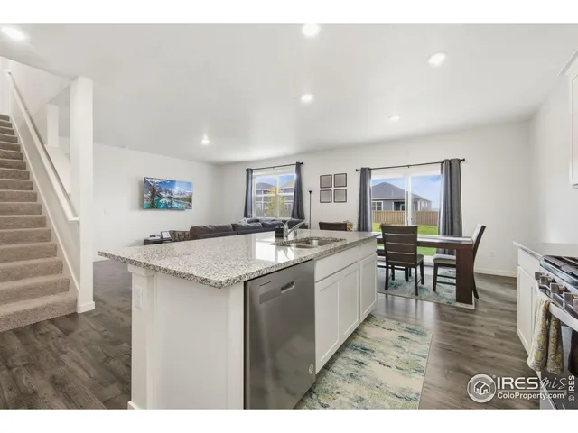 a open kitchen with kitchen island a sink table and chairs