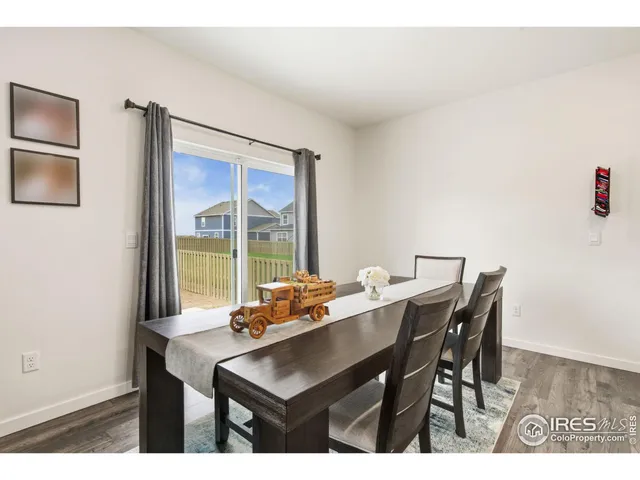 a view of a dining room with furniture and a window