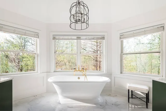 a white bath tub sitting next to a window