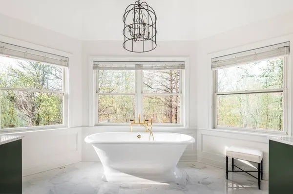 a bathroom with a bathtub and a window
