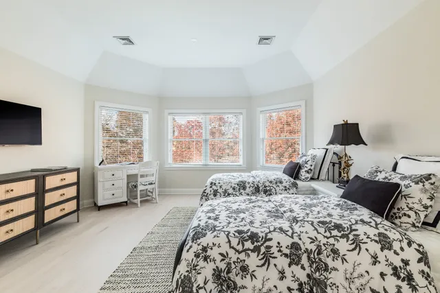 a bedroom with a large bed and a window