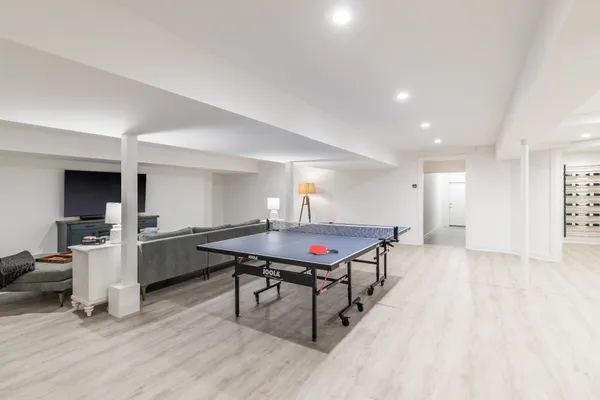 a room with stainless steel appliances kitchen island a table and chairs in it