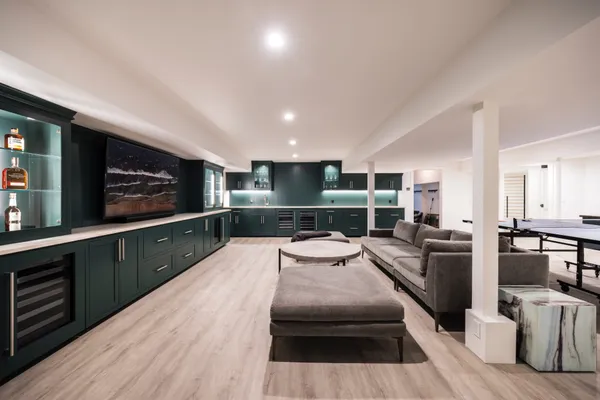 a large kitchen with stainless steel appliances a large counter top a stove and a sink