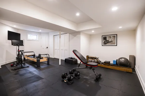 a room with gym equipment and a flat screen tv