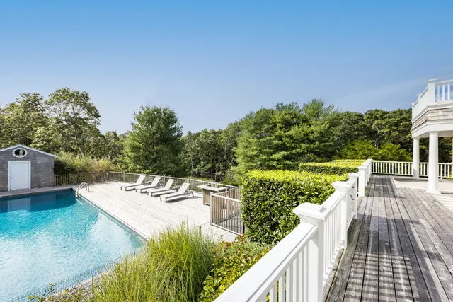 a view of balcony with wooden floor and yard