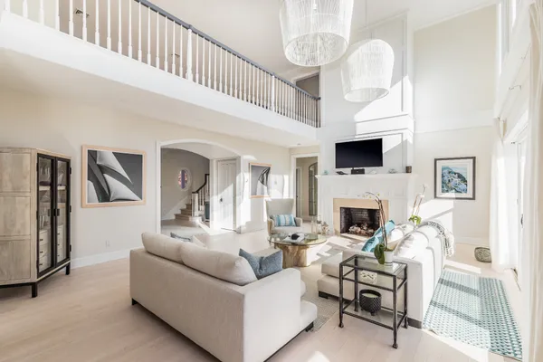 a living room with furniture a fireplace and a large window