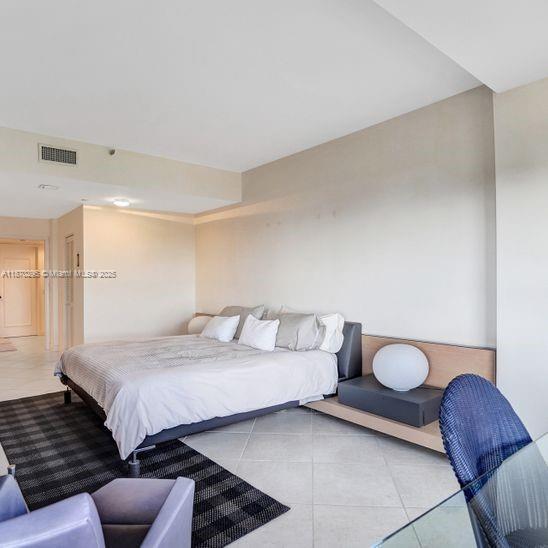 151 Crandon Boulevard, Unit 1130 Key Biscayne, FL 33149 - Photo 11 of 30 a bedroom with a bed and couch